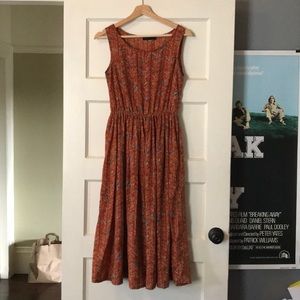 Rust colored dress with beige and teal accents
